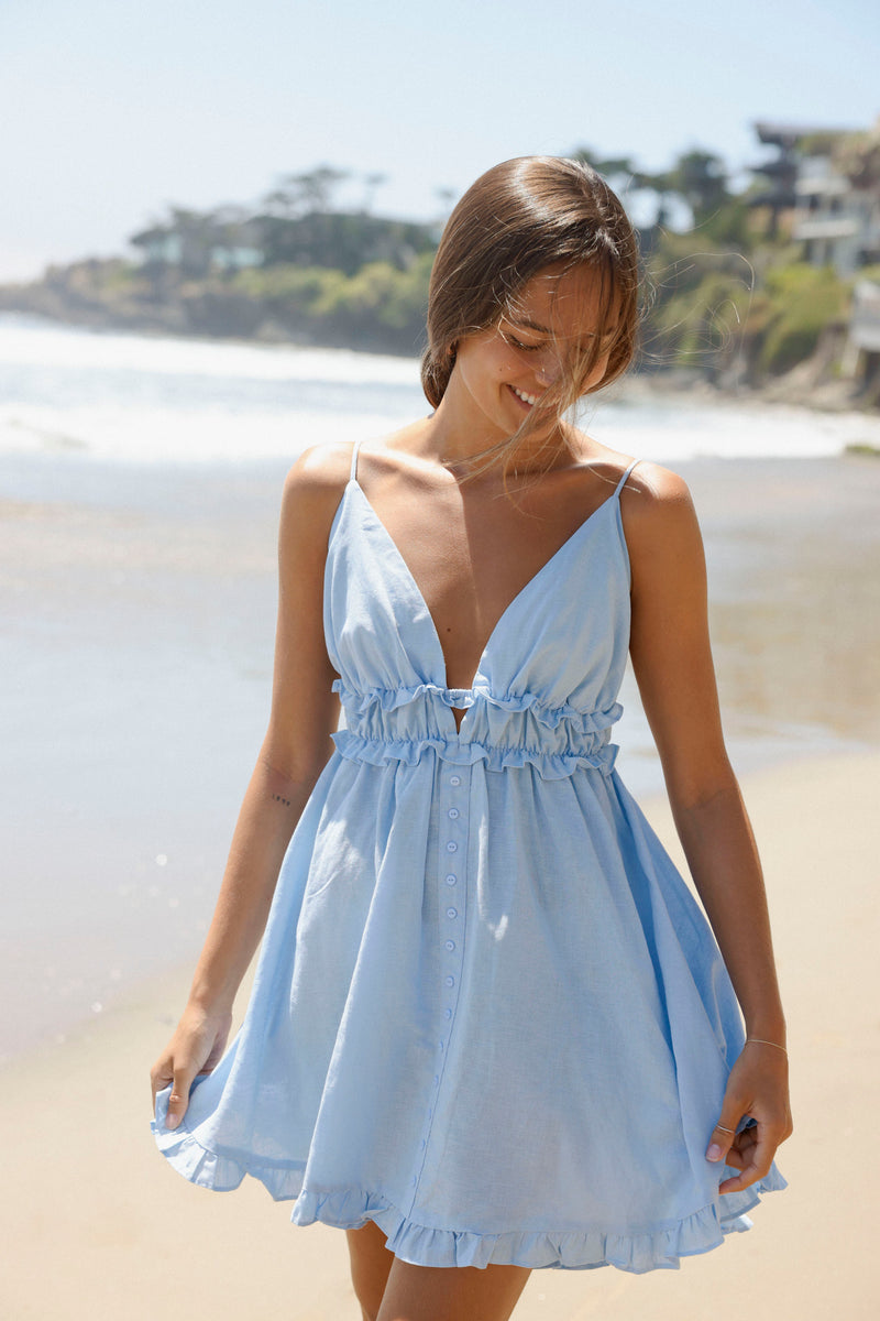 Meet your new go-to everyday dress! Our Corfu Dress features thin straps, a low back, and sweet ruffle detailing. It is completely adjustable. Its full skirt and gorgeous light blue color make it the sweetest dress!